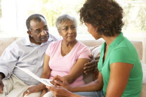 caregiver assisting senior couple